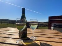 Barnharrowglampingpodsexternalviewwithwhitewineontable-1920w
